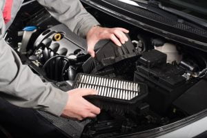 mechanic changing the air filter on a car royalty free image 1594045393